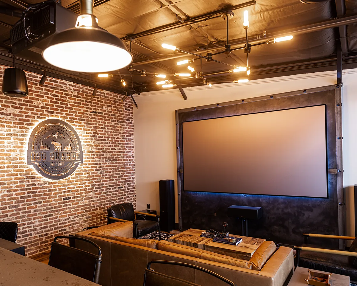 TV room with brick wall and beautiful lighting.